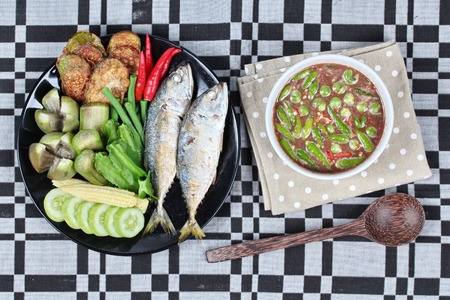 Spicy shrimp paste dip as " Nam Prik Kapi" served with side dish as deep fired mackarels,boiled long-eggplant,lentils,winged bean ,red hot chili pepper and sliced cucumber.の写真素材
