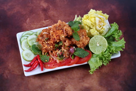 Spicy fried chicken salad (Yum Kai Zap in Thai) .の写真素材
