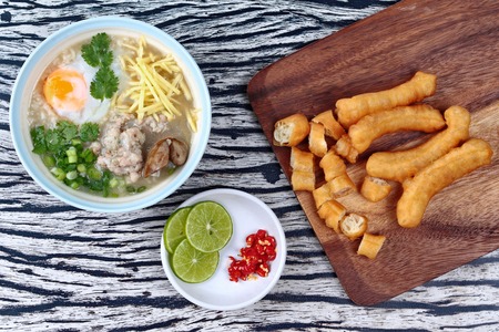Rice porridge with mined pork and chicken lever served with side dish as Patongko (deep-fried dough stick) and spicy sour fillin.の写真素材