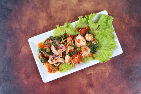 Fried spicy mixed herb  with squid and lettuce.の写真素材