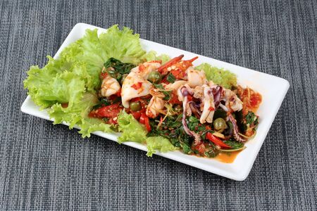 Fried spicy mixed herb  with squid .の写真素材