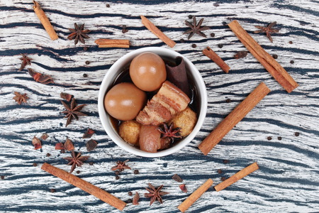 Thai Recipes : Stewed boiled egg with tofu and streaky pork ,call Khai Palo in Thai, take photo with herbs as Chinese star anise ,cinnamon,black pepper,cilantro roots and stemsの写真素材