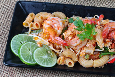 Close up of Thai fried macaroni with shrimp , call Pad Thai Macaroni in Thai. Selective focus.の写真素材