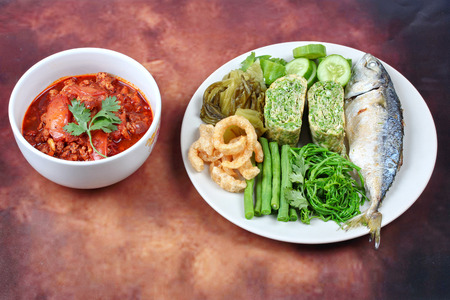 Spicy meat and tomato dip,Nam Prik Ong in Thai,Northern style chili and tomato dip ,with side dish as fired mackarels,winged bean,cha,rolled cha omelet,pork rind,pickle lettuce and cucumber.の写真素材