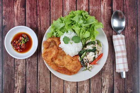 Thai food , Rice topped stir - fried spicy basil with crab and minced-pork omelet served with spicy sauce call Kao Pad Kra Prao Poo.の写真素材