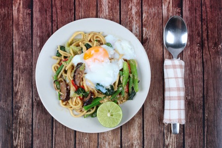 Thai cuisine ,Fried sour sweet Chinese noodle with soft-boiled egg and green lemon.の写真素材