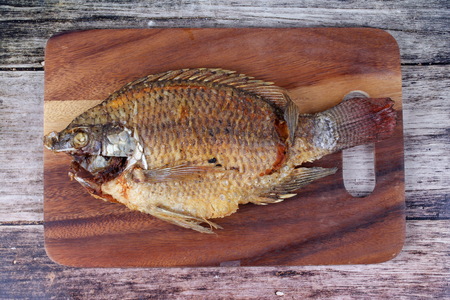 Ready served of deep fried Nile tiapia fish on butcher served. Call Pla Nil Tod in Thai.の写真素材