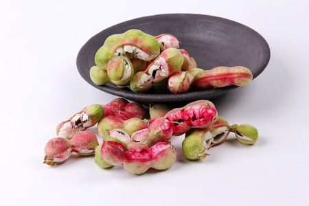 Manila tamarind fruit on black dish .の写真素材