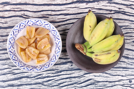 Thai dessert , Ready served of boiled banana in syrup and wholes of banana.の写真素材