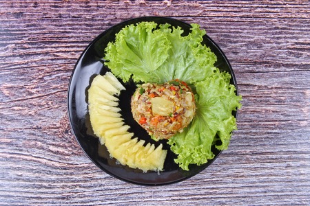 Thai cuisine , Fried organic red brown jasmine rice with pineapple in yellow curry powder call Khao Pad Subparod in Thai.の写真素材