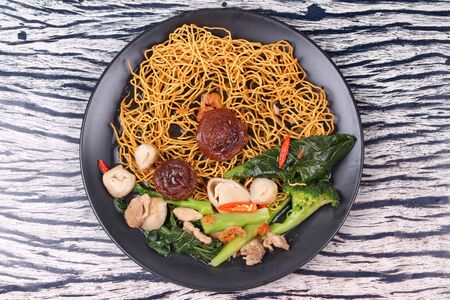 Chinese food ,Crisy  noodle topped kale soup with minced chicken ,mushroom and dried shrimp call Mee Krob Rad Naa.の写真素材