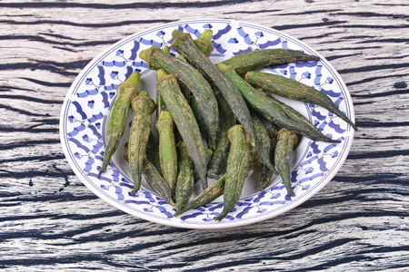 Thai Organic snack for health ,Crispy Okra dried seasoning in Thai pattern dish.の写真素材