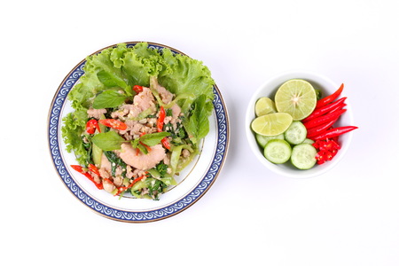 Popular Thai food of fried spicy basil with minced pork and sliced pork topped  lettuce and spicy side disk.の写真素材