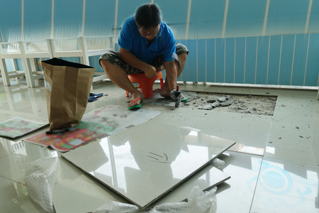 Homemade Replacing floor tiles , The man was broken, and a tile adhesive plaster out the old to cement glue. For a new tile support again on same area .のeditorial素材