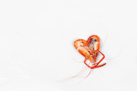 Ready streamed large fresh prawns in heart shape  isolated on white backgroundの写真素材