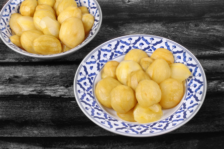 Thai traditional dessert,Little green mango compote , Mini golden mango in syrup, served in Thai pattern plate. Call Ma Muang Bao Chae Im in Thai .の写真素材