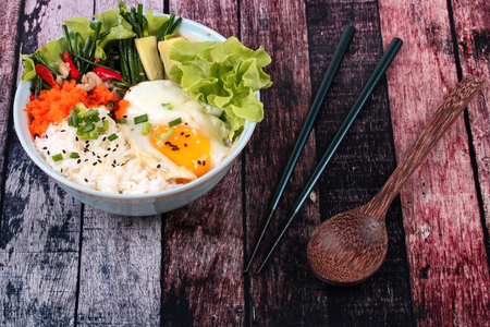 Thai jasmine rice in Japanese style,Rice is topped soft boil eggs and fried chicken with garlic chives ,Oyakodon,in Japanese pattern bowl.の写真素材
