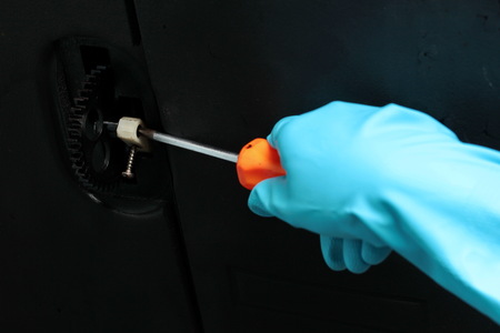 Technician wear rubber grove to use four-pointed screwdriver for gear machine maintenance.の写真素材