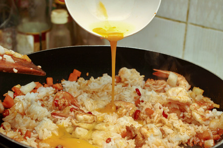 Homemade cooking,Fried Jasmine rice with prawns in yellow powder topped sliced onion and lentilsの写真素材