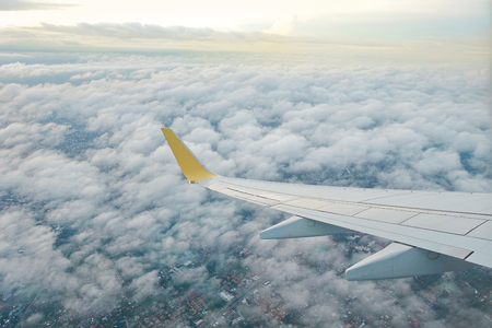 Take a Photo from plane of above the cloud in sky and wing of airplane.の写真素材