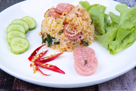 Thai traditional food, Fried  jasmine rice with Thai sour sausage topped cucumber, kale and green oat.の写真素材