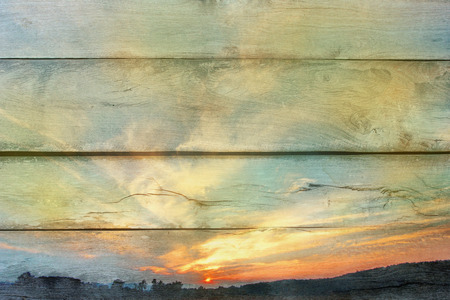 Sky, clouds, mountains, fields and dawn silhouettes.の写真素材