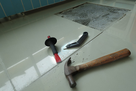 Homemade Replacing floor tiles , The tiles was broken, and a tile adhesive plaster out the old to cement glue. For a new tile support again on same area .の写真素材