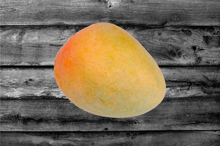 Popular fruit,Ripe orange red R2E2 Mango on woodの写真素材
