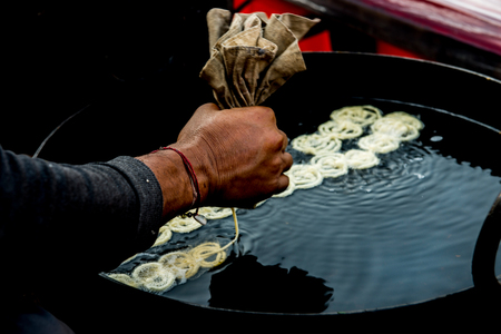 Homemade Traditional India cooking,Squeeze the hand with flour dough pastry seasoned coil is shaped...