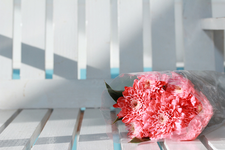 Colorful pink rose flowers bouquet is a combination rests on white wood. Selective focusの写真素材