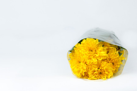 Colorful yellow flowers bouquet is a combination rests on white background. Selective focusの写真素材