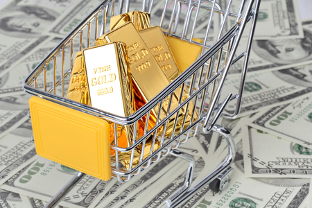 6 Gold bars 1 kg, in shopping  trolley with yellow mark for supermarket paced on bank note.の写真素材