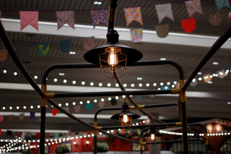 Antique lamp in vintage style on metal racks in a train yard flag colours and bokeh