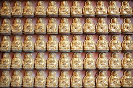 Golden Buddha set in order within temple building at  Wat Borom Racha Kanchanapisek Anusorn (or Wat Leng Noei Yi 2)のeditorial素材