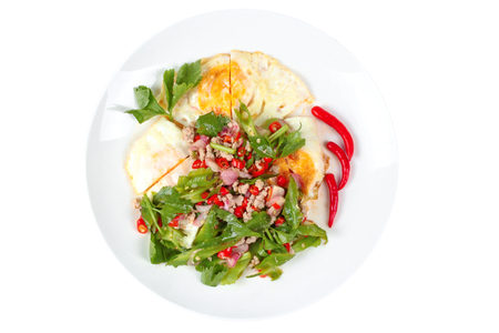 Isolated of spicy wing bean with minced pork topped fried egg as Yum Khai Doa in Thaiの写真素材