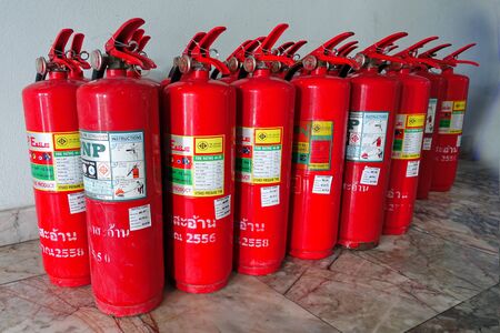Red tanks of  Chemical fire extinguisher  were lined up waiting to check its performance before reuse.のeditorial素材