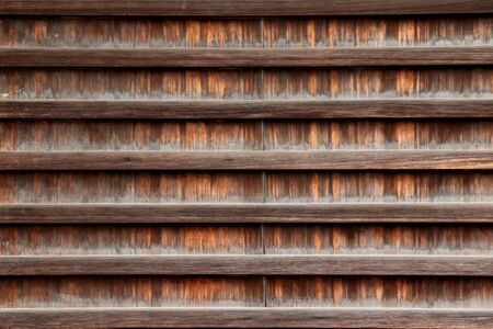 Close up ,Texture of old wood japanese art of outsite temple wall.の写真素材