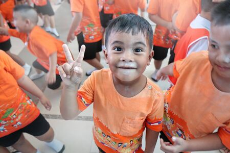 Samutprakarn, Thailand ,23 Nov 2018, Young children dressed in orange patterned fun and enjoy with the primary school activities.のeditorial素材