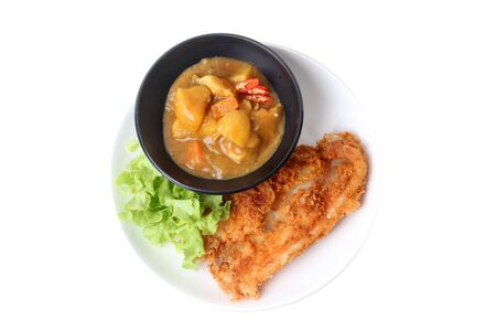 Ready served of crispy fried dolly fish with Japanese yellow curry topped green oak.の写真素材