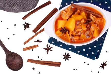 Isolated of Thai massaman curry paste recipe served in Thai pattern bowl and herbsの写真素材
