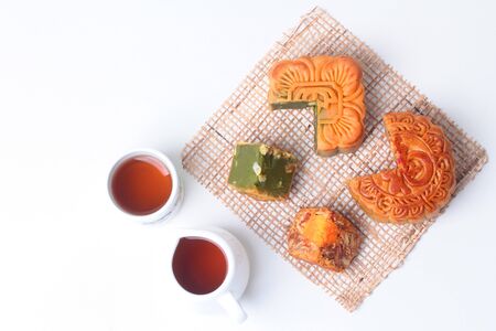 Round mooncake
8 grains and salted eggs and squred mooncake filled red beans, stirred in green tea and chopped macadamia nuts served with tea and teapot.の写真素材