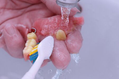 Use the toothbrush to clean teeth partial denture.の写真素材