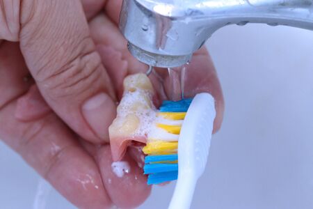 Use the toothbrush to clean teeth partial denture.の写真素材
