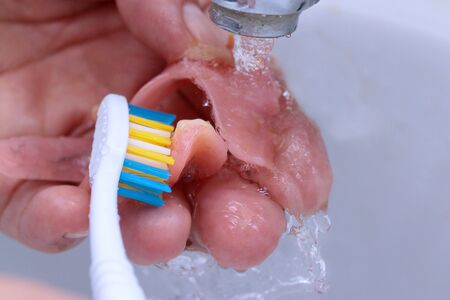 Use the toothbrush to clean teeth partial denture.の写真素材