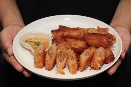 Ready served of deep fried spring roll as flour sheet wrap  fried vermicelli served with sweet sauce.の写真素材