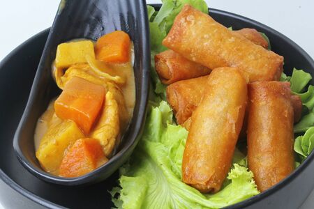 Ready served of deep fried spring roll as flour sheet wrap  fried vermicelli served with Japanese yellow curry and sweet sauce.の写真素材