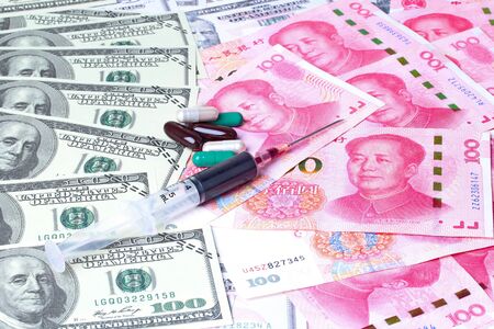 Varites dollar money ,The USA banknote ,and Yuan Banknote ,Chinese banknote  lay spread double with colorful drugs and blood in syringe on banknotes lの写真素材