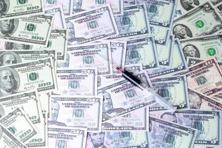 Varites dollar money ,The USA banknote ,and blood in syringe on banknotes lay spread double.の写真素材
