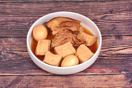 Stewed boiled egg with tofu and streaky pork in Chinese brown soup.の写真素材