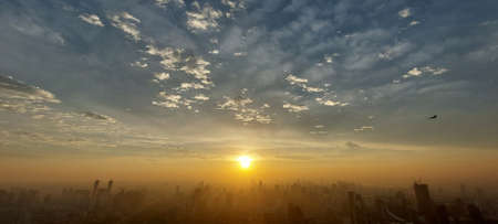 Air Pollution in the City, Wide engle view of Morning sunrise, PM 2.5 fog and dust in a city crowded with buildings. This photo contain burry.の写真素材